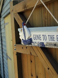 Row of beach huts with 'gone to beach' sign - credit Thanet Tourism.JPG