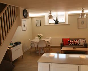 Old School Mews Lounge area with sofa and dining table